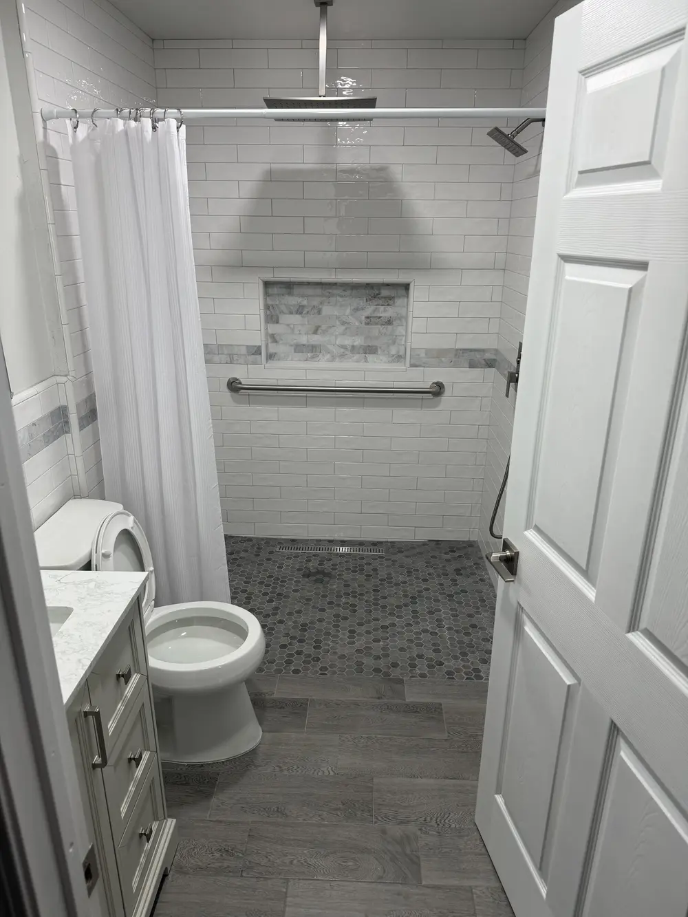Finished bathroom remodel with fresh paint, tile, and fixtures by Kern General Construction in Bakersfield