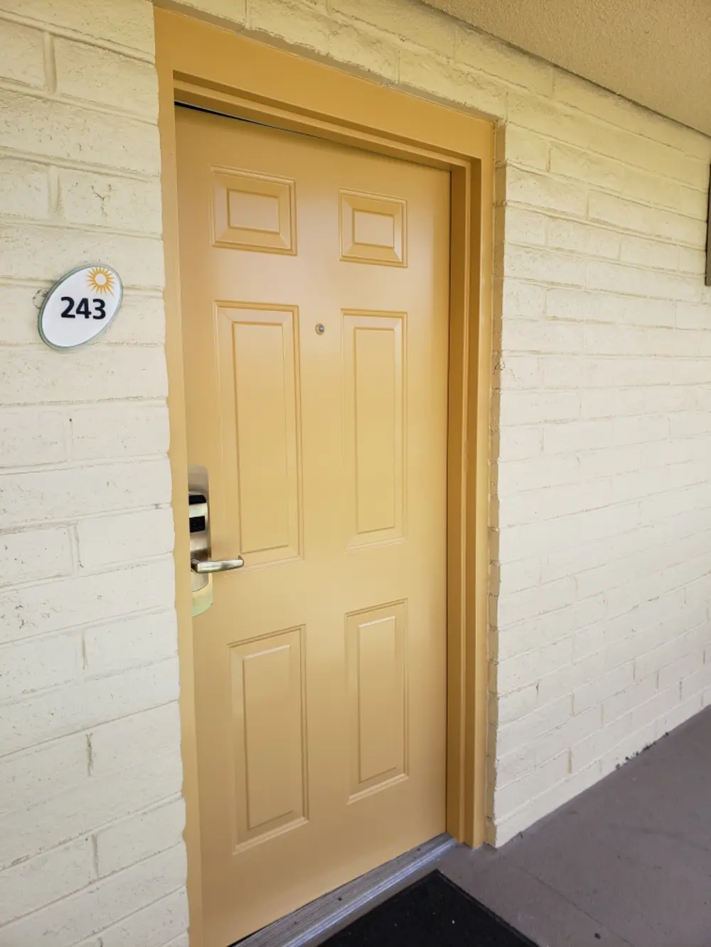 Same exterior door freshly repainted in clean warm gold with crisp edges, exterior painting in Bakersfield, CA
