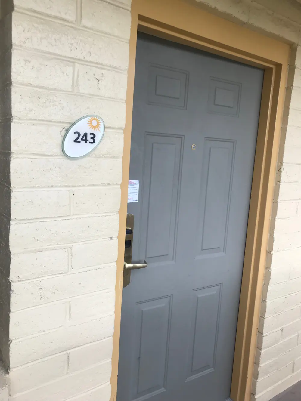 Weathered, faded grey exterior unit door before repainting